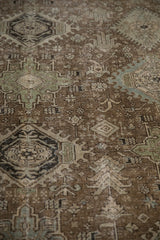 Angled view of the abrased pile showing geometric starbursts on a fine vintage Heriz carpet.