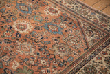 Close-up of vintage Mahal carpet showing dusty rose field, floral palmettes, and exposed knot heads.