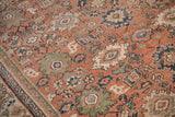 Worn vintage Mahal rug, faded brick red, floral palmettes, blue accents, and visible knot heads.