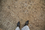 Worn, low-pile texture of a vintage Tabriz carpet showing its floral arabesque with platinum highlights.