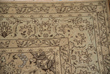 Low-pile wear on the corner spandrel and floral borders of a distressed Persian Tabriz carpet.