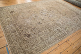 Ornate corner spandrel and floral vine border of a distressed vintage Persian Tabriz rug.