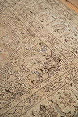 Artificial silk inlays highlight floral patterns on the low, time-softened pile of a distressed Tabriz carpet.