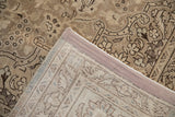 A view of the distressed Tabriz rug's hand-knotted back and professionally restored side selvage.