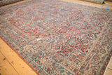 Angled view of a vintage Heriz carpet with a geometric medallion and Samovar Turtle design border.