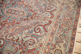 Close-up on the reciprocating Samovar Turtle border of a distressed Persian Heriz carpet.