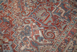 Low-pile texture of a vintage Heriz carpet with Samovar Turtle motifs in red, blue, and beige.