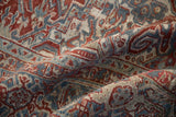 Softly worn pile on a vintage Heriz carpet with geometric motifs in sapphire blue and cherry red.