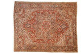 Distressed vintage Heriz carpet featuring rust red, geometric medallion, and Turtle Samovar border.