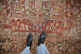 Close-up of distressed Heriz carpet with geometric blossoms and Turtle Samovar border.