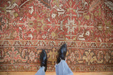 Distressed vintage Mehrivan carpet with geometric floral motifs in dusty red, gold, and silver.