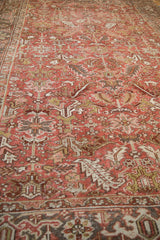 Textured field of the vintage distressed Mehrivan rug showing geometric blossoms in muted red.