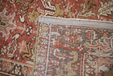 Distressed Mehrivan rug with worn brick red pile showing faint foundation.