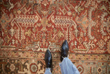 Distressed Mehrivan carpet, germinating boteh field, Turtle Samovar border, dusty brick red palette.