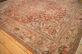 Low pile and even wear of a distressed vintage Ahar carpet with curvilinear floral patterns.