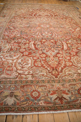 A low angle view across the distressed Ahar carpet showing its worn texture and sprawling floral design.