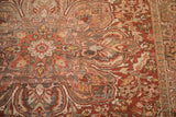 Time-softened red, silver, and gold tones on the worn, floral pattern of a vintage Ahar carpet.