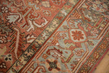 Distressed Heriz rug detail: Samovar Turtle border and geometric field in faded red, slate blue.