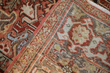 Folded view of distressed Heriz rug, geometric blossoms, and Samovar Turtle border motif.