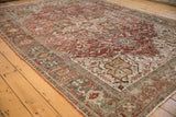 Distressed Heriz carpet border detail with dusty teal and ivory patterns and softened raspberry field.
