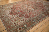 Distressed vintage Heriz border with dusty teal, ivory, and faded raspberry geometric motifs.