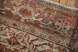 Distressed vintage Heriz pile close-up, showing muted raspberry, teal, and sand.