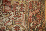 Vintage Heriz carpet, geometric border, primitive floral field, worn texture, brick red, dusty gold.