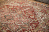 Vintage distressed Heriz field with primitive floral cross-sections and abrash.