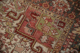 Geometric primitive floral cross-sections and distressed pile in brick red and dusty gold.