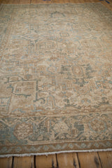 Distressed vintage Heriz rug pile highlighting geometric blossoms and Samovar Turtle border.