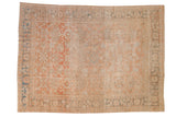 An antique distressed Mahal carpet with an allover floral pattern in soft cantaloupe, ivory, and powder blue.