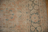 Wear across the knot heads and exposed foundation of a distressed antique Mahal rug.