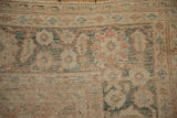Antique Mahal carpet border showing floral palmettes with heavy abrashes and visible knot heads.