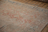 Worn pile and heavy abrashes on an antique Mahal carpet in pale cantaloupe and blue.