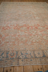 Angled perspective across the distressed Mahal's soft, time-worn pile and muted floral patterns.