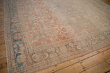 Soothing tone-on-tone shades across the floral field and borders of a distressed Mahal carpet.