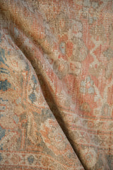 Soft, draped pile of a distressed antique Mahal rug showing heavy abrashes and worn texture.