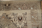 Corner view of a vintage Bibikabad rug showing the floral border and evenly worn, low-pile texture.