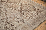 Angled view of the distressed, low-pile texture on a Bibikabad carpet's floral trellis pattern.