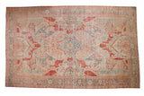 Vintage distressed Mahal carpet with sprawling floral medallions in cinnabar red, powder blue, and ivory.