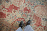 Low pile and distressed texture of a vintage Mahal rug with cinnabar red and powder blue floral details.