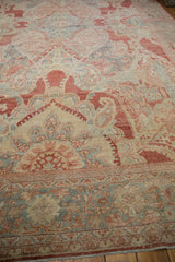 Angled perspective on the distressed Mahal carpet's time-softened, low-pile texture.