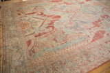 Angled view showing the even wear across the sprawling floral patterns of a vintage Mahal carpet.
