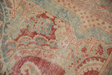 Close-up on the shadow relief floral outlines and distressed texture of a Mahal carpet.