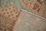Folded corner of a vintage Mahal carpet revealing its machine-bound edge and even wear.