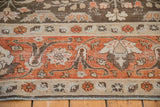 Traditional Tabriz carpet distressed border with textured terracotta, beige, charcoal motifs.