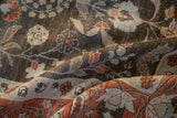 Time-softened terracotta, beige, charcoal pictorial motifs on the distressed Tabriz carpet.
