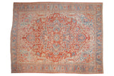 Vintage distressed Heriz carpet with an oversized medallion in faded cinnabar red, powder blue, and ivory.
