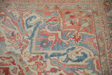 Close-up on the Karaja style border of a distressed Heriz carpet, showing worn, serrated leaf motifs.