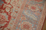 Detailed Karaja style border in red and blue on a distressed Heriz with low, even wear.